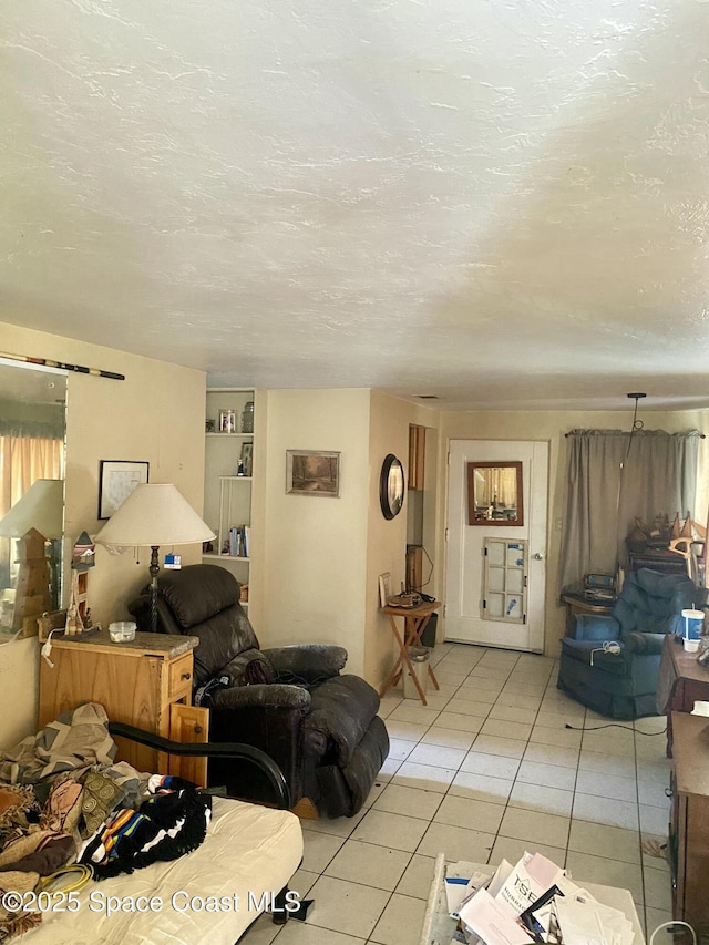 living room with a textured ceiling and light tile patterned floors