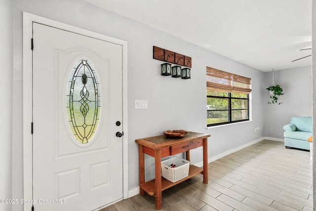 foyer entrance featuring light wood-type flooring and baseboards