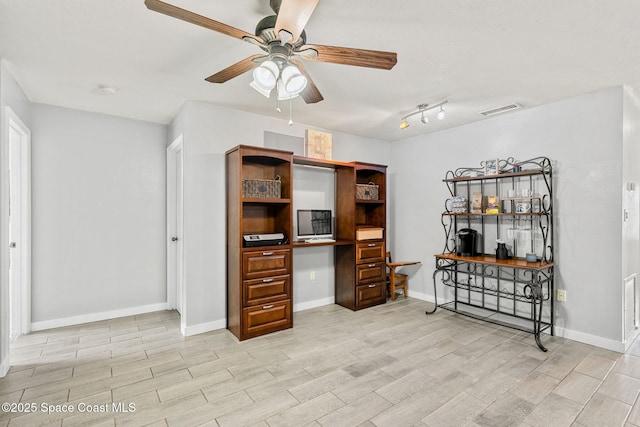 office featuring light wood-type flooring, built in study area, visible vents, and baseboards