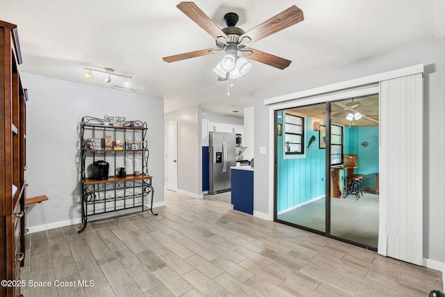 empty room with light wood-style floors, visible vents, ceiling fan, and baseboards