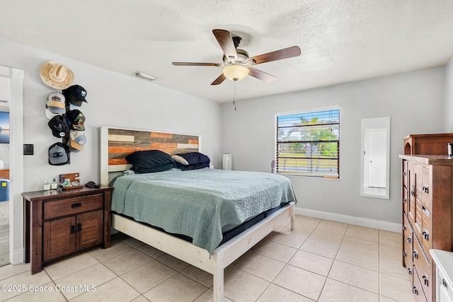 bedroom featuring a textured ceiling, light tile patterned flooring, visible vents, and baseboards