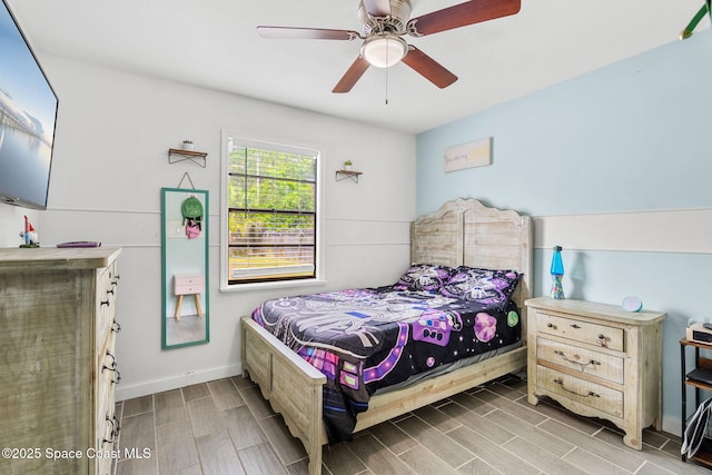 bedroom with wood tiled floor, ceiling fan, and baseboards