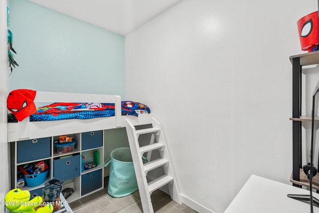 bedroom with wood tiled floor