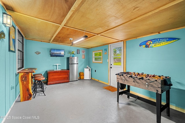 playroom with concrete flooring and baseboards