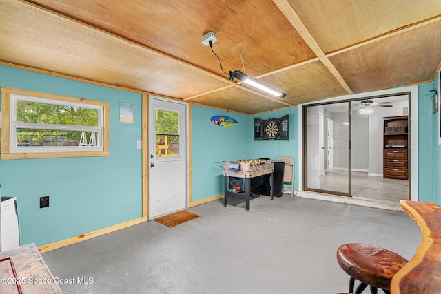 interior space with concrete flooring and baseboards