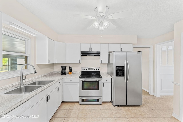 kitchen featuring white cabinets, light countertops, stainless steel appliances, under cabinet range hood, and a sink