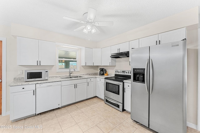 kitchen featuring white cabinetry, under cabinet range hood, a sink, and stainless steel appliances