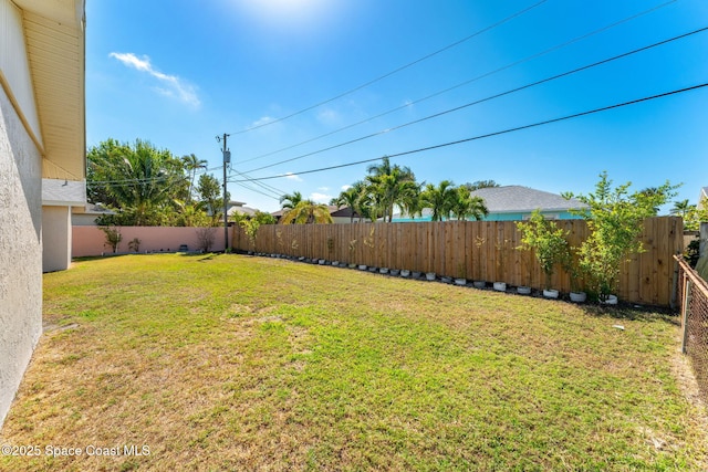 view of yard with a fenced backyard
