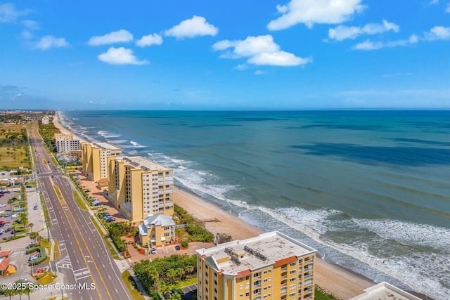 aerial view featuring a water view and a beach view