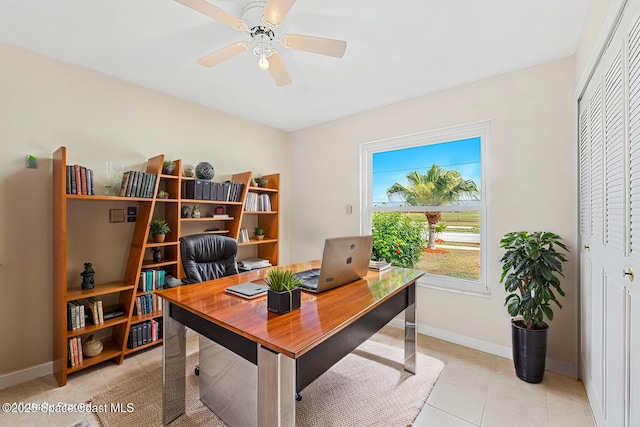 office featuring light tile patterned flooring, baseboards, and ceiling fan