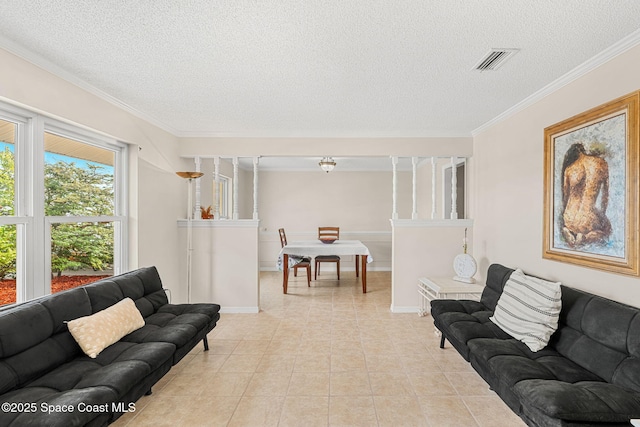 living room featuring a textured ceiling, visible vents, baseboards, ornamental molding, and light tile patterned floors