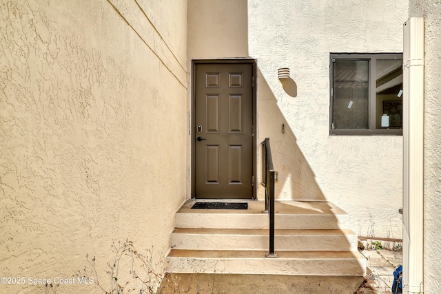 doorway to property with stucco siding