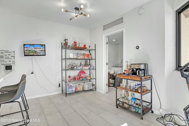 home office featuring visible vents, baseboards, and an inviting chandelier