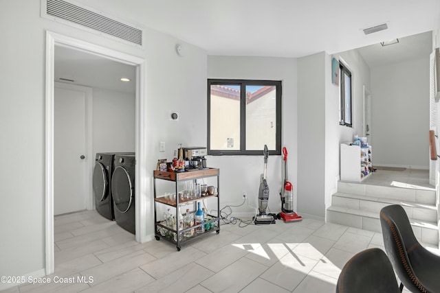 interior space featuring separate washer and dryer, visible vents, and baseboards