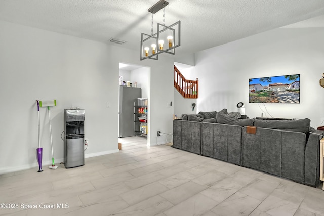 living room with stairway, baseboards, visible vents, a textured ceiling, and marble finish floor