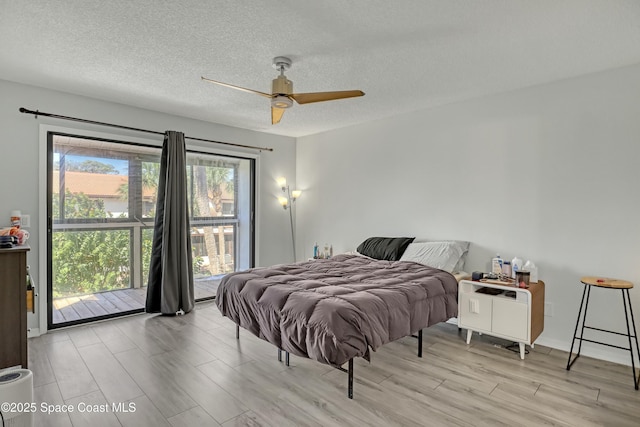 bedroom featuring a ceiling fan, access to exterior, light wood-style floors, and a textured ceiling