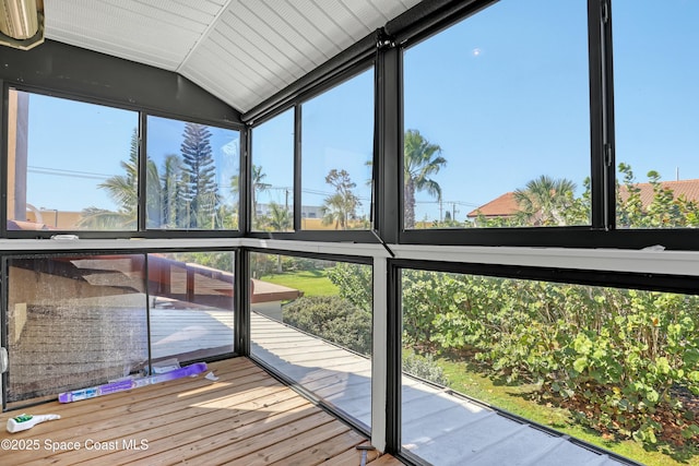 unfurnished sunroom featuring lofted ceiling