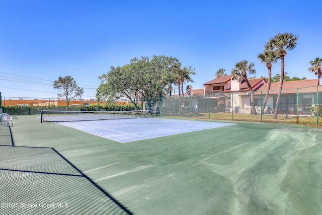 view of sport court featuring fence