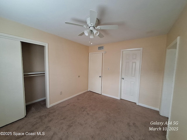 unfurnished bedroom with baseboards, visible vents, carpet floors, ceiling fan, and a closet