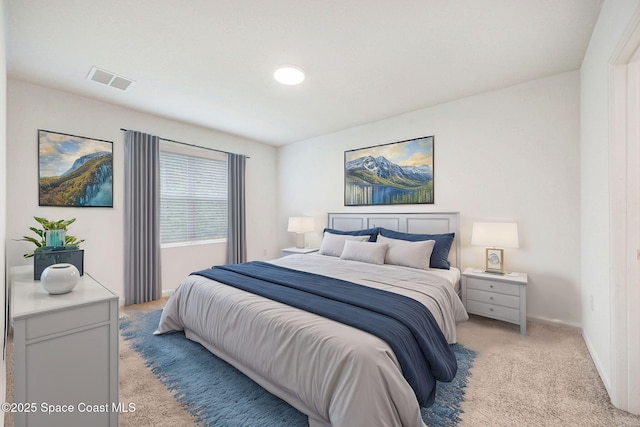 bedroom with visible vents, light carpet, and baseboards