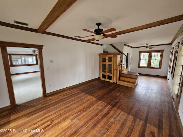 unfurnished living room featuring beam ceiling, wood-type flooring, visible vents, and baseboards