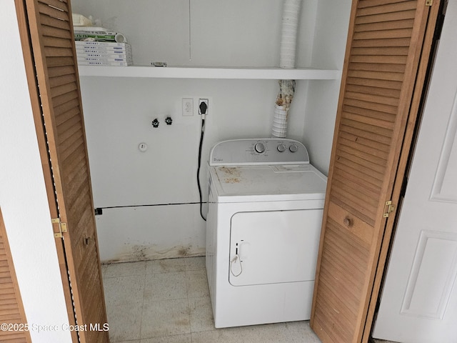 washroom with laundry area and washer / dryer