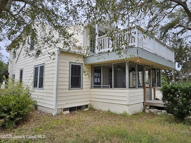 rear view of house featuring a sunroom