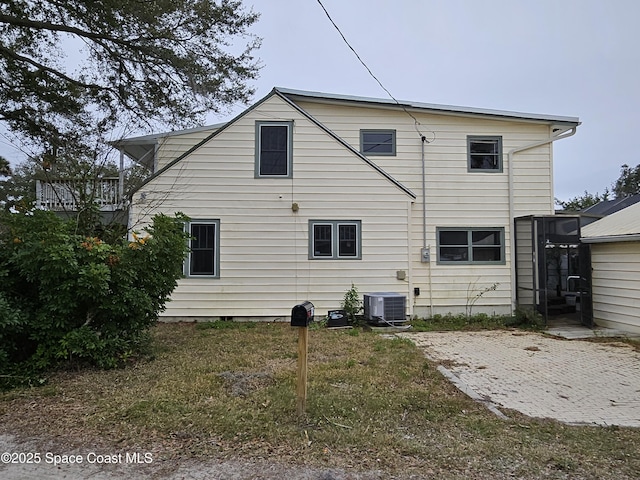 back of house featuring central air condition unit