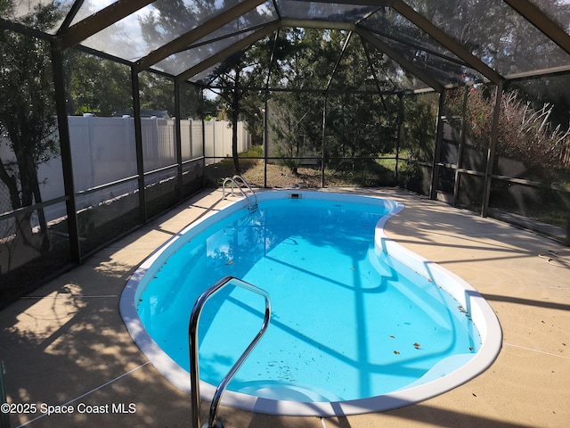 view of pool featuring a lanai and a patio