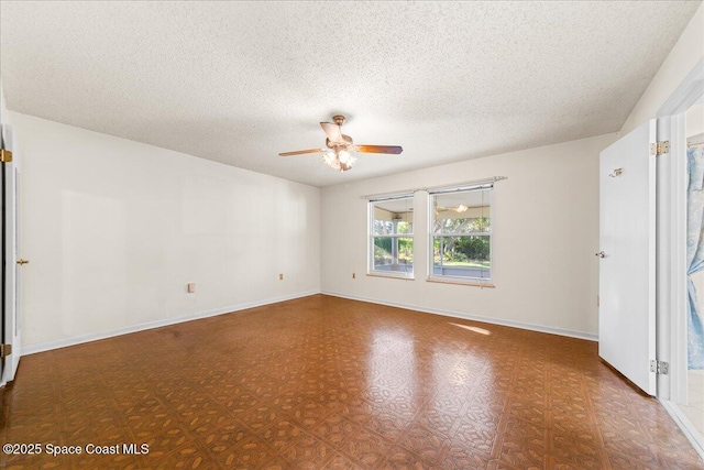 empty room with baseboards, a textured ceiling, and ceiling fan