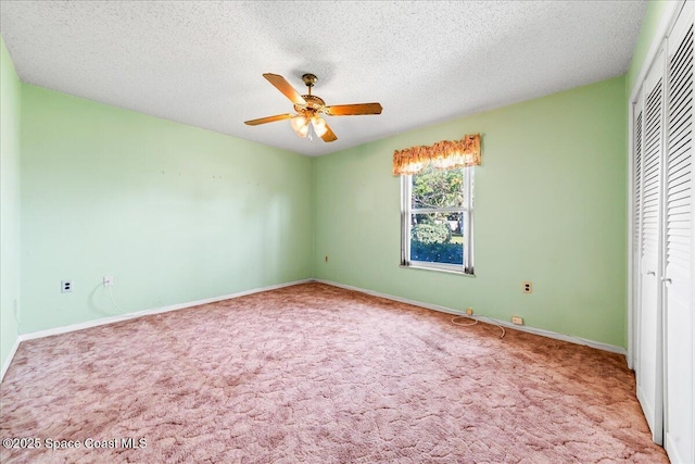 unfurnished bedroom with a ceiling fan, baseboards, a closet, a textured ceiling, and carpet flooring