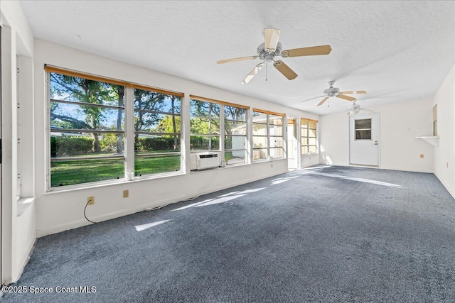 interior space with cooling unit, a textured ceiling, ceiling fan, and carpet flooring