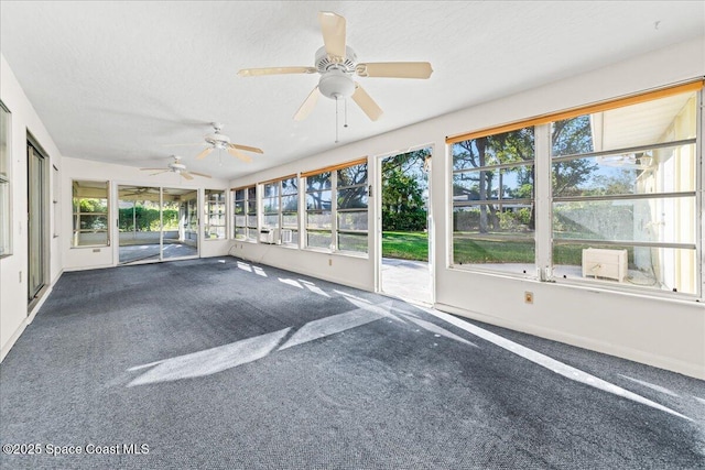 unfurnished sunroom featuring plenty of natural light and ceiling fan