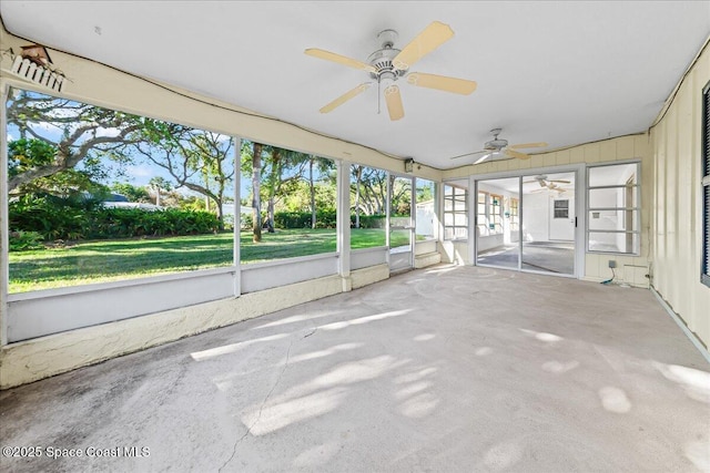 unfurnished sunroom featuring a ceiling fan