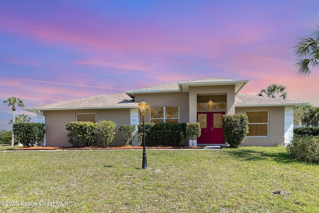 view of front of home featuring a front lawn and stucco siding