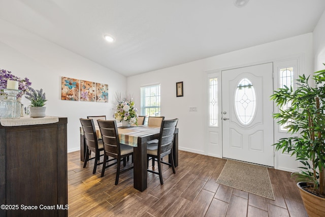 dining space with vaulted ceiling, dark wood-style floors, and baseboards