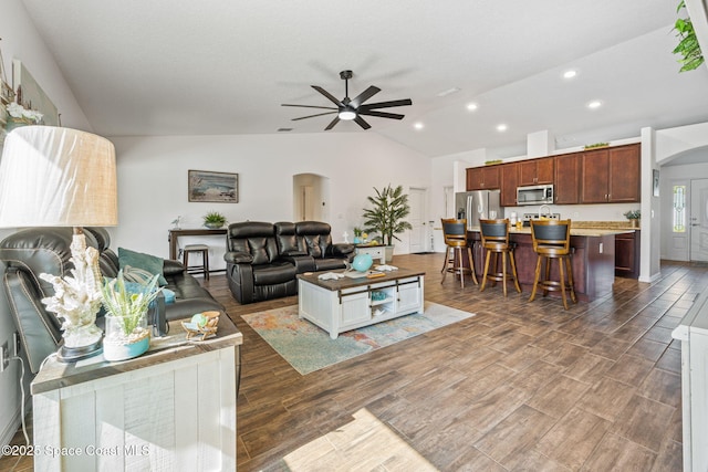 living room with wood finished floors, lofted ceiling, recessed lighting, arched walkways, and ceiling fan