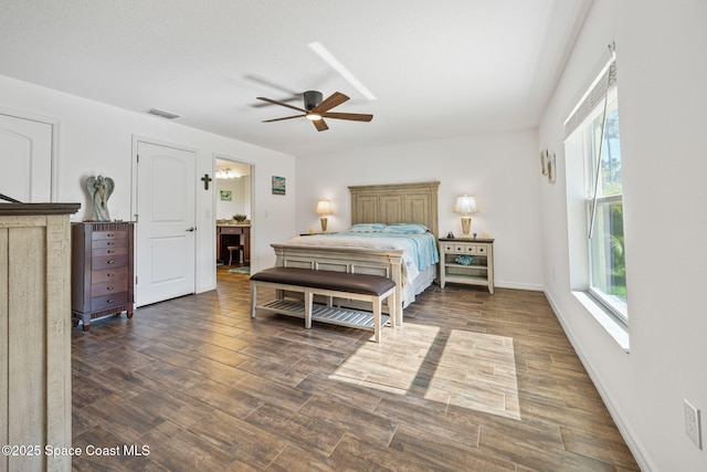 bedroom with ceiling fan, dark wood-style floors, visible vents, and baseboards