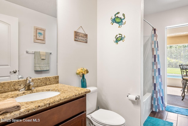 full bath with toilet, vanity, and shower / bath combo