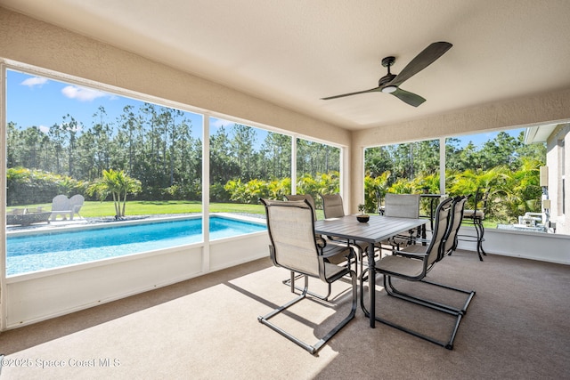 sunroom / solarium featuring ceiling fan