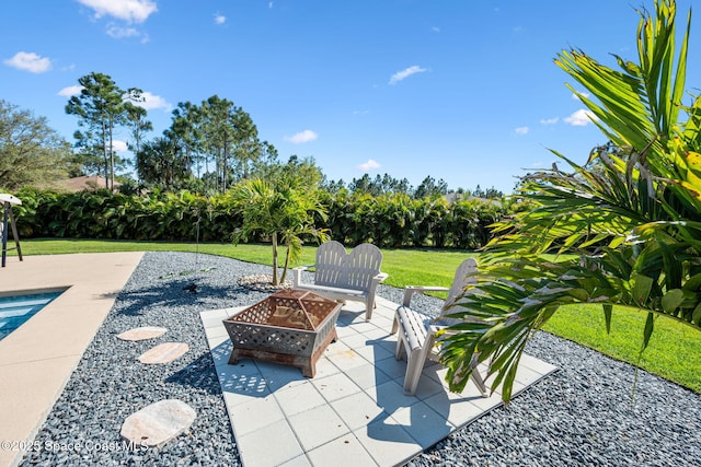 view of patio with an outdoor pool and an outdoor fire pit