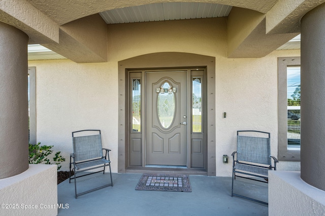 entrance to property with stucco siding