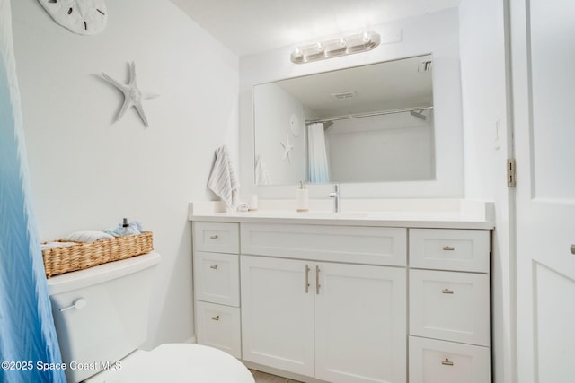 full bath featuring visible vents, toilet, and vanity