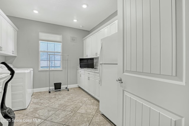 laundry room featuring washing machine and clothes dryer, baseboards, recessed lighting, light tile patterned flooring, and cabinet space