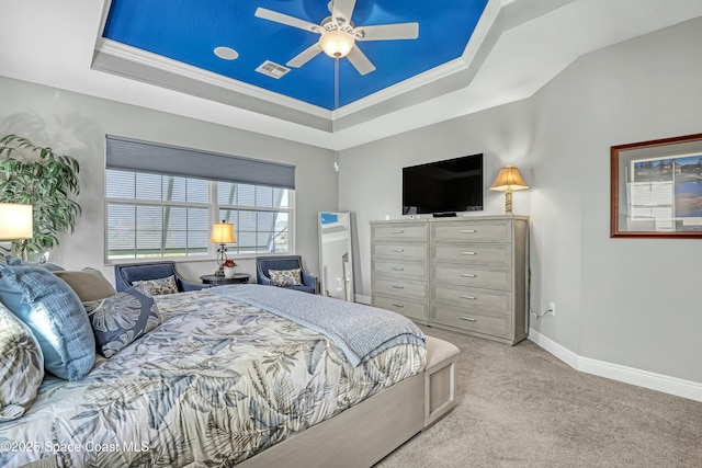 bedroom with a raised ceiling, baseboards, visible vents, and carpet floors