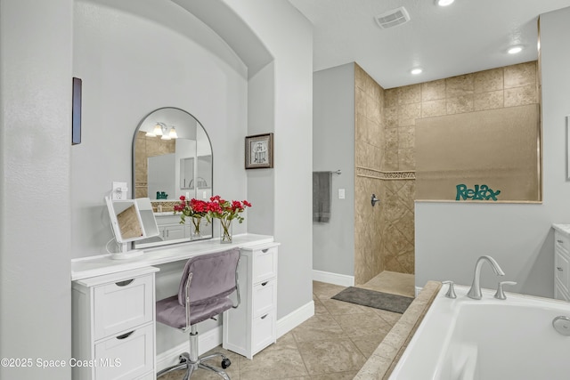 bathroom featuring vanity, visible vents, baseboards, a walk in shower, and a bath