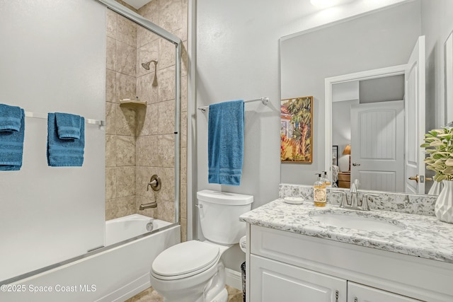 full bathroom with bath / shower combo with glass door, toilet, and vanity