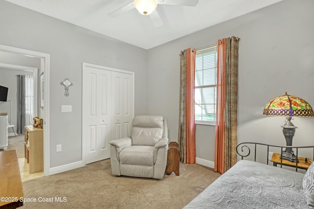 bedroom featuring a closet, baseboards, carpet, and ceiling fan