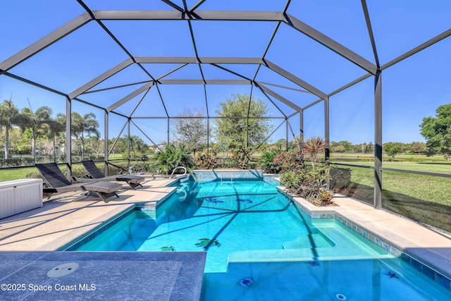 outdoor pool featuring glass enclosure and a patio