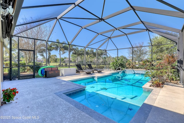 outdoor pool with a lanai and a patio area